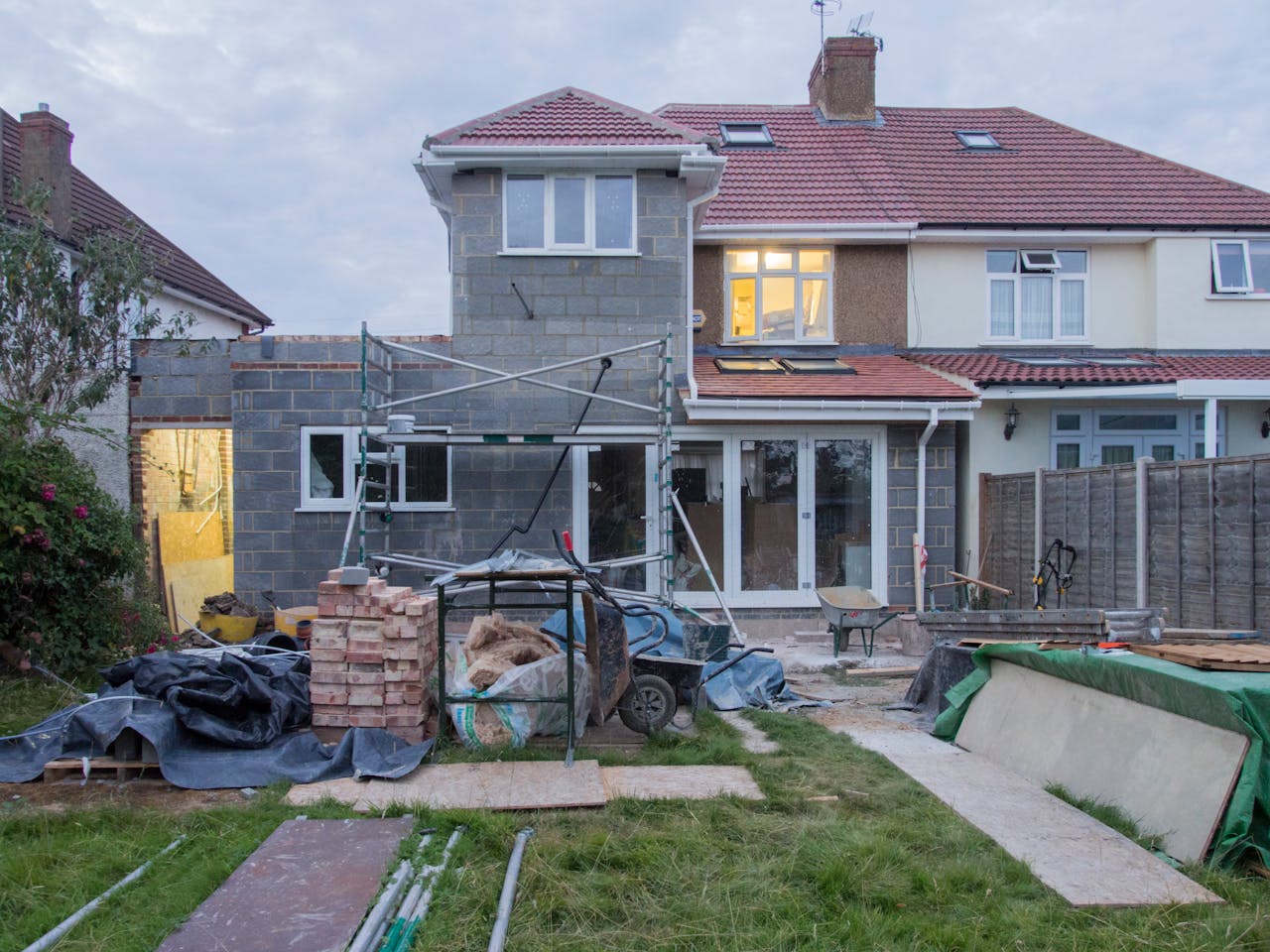The Art of Drawing Readers In: Your attractive post title goes here A suburban house undergoing major renovations with scaffolding and building materials.
