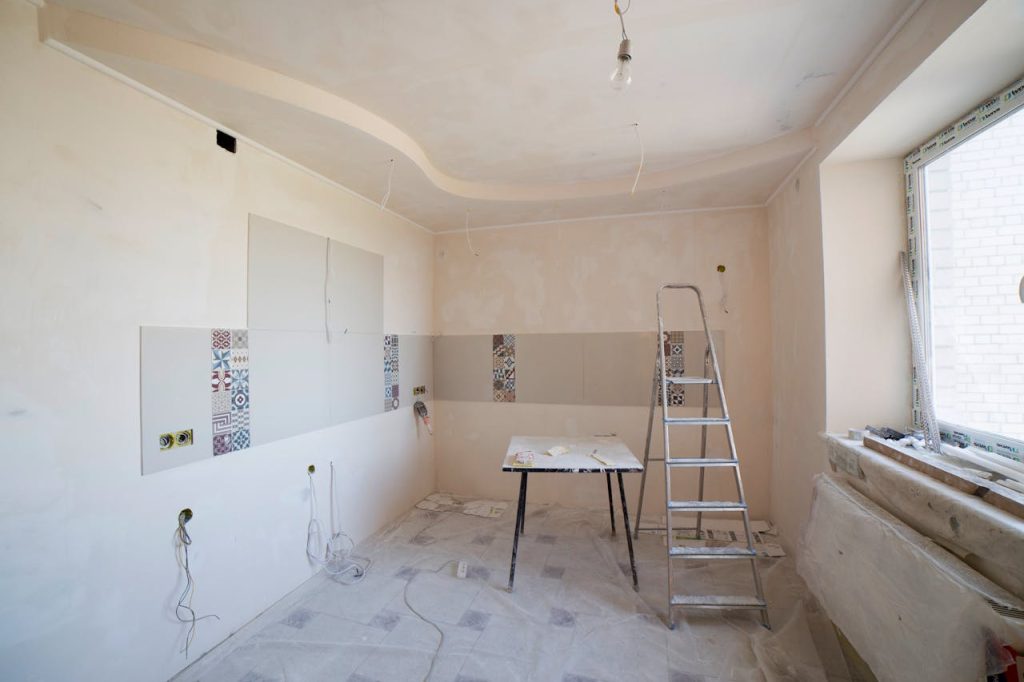 Crafting Captivating Headlines: Your awesome post title goes here Spacious kitchen under renovation with ladder and tools, showcasing a fresh new design.